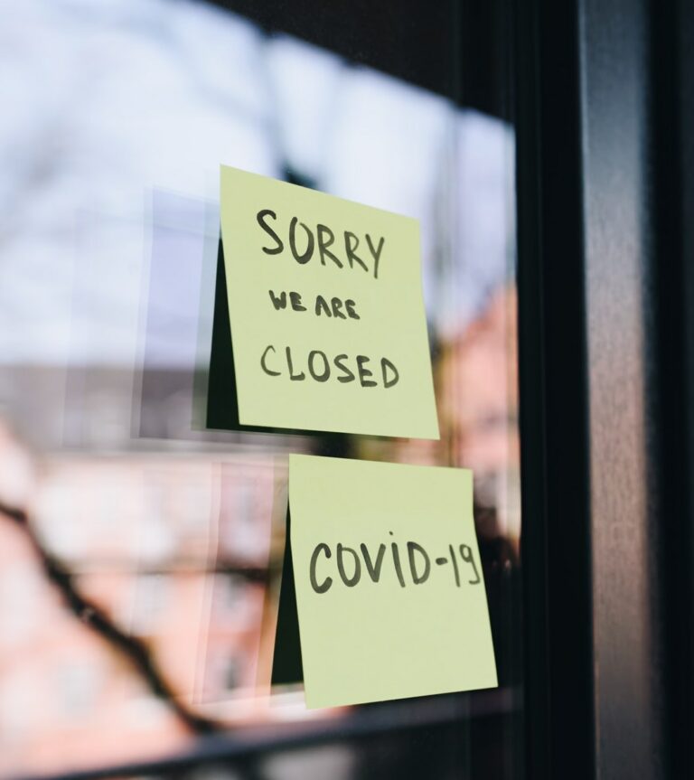 post-it note on window that reads Sorry We Are Closed Covid-19