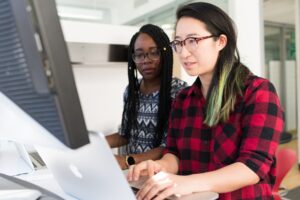 Women collaborating at computer screen