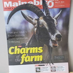 Magazine cover showing a headshot of a goat with beard and horns