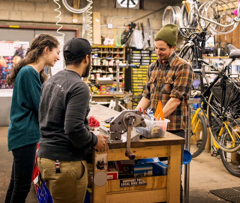 three people in bike shop